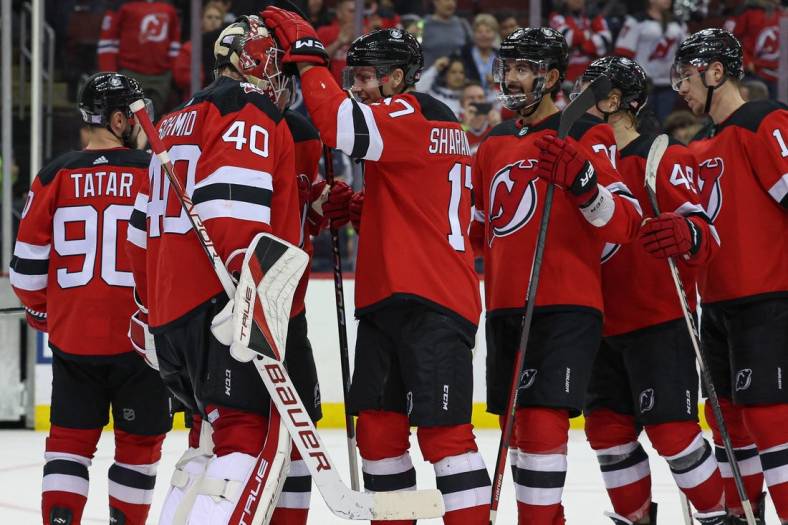 Nov 12, 2022; Newark, New Jersey, USA; New Jersey Devils goaltender Akira Schmid (40) celebrates with teammates after defeating the Arizona Coyotes at Prudential Center. Mandatory Credit: Vincent Carchietta-USA TODAY Sports