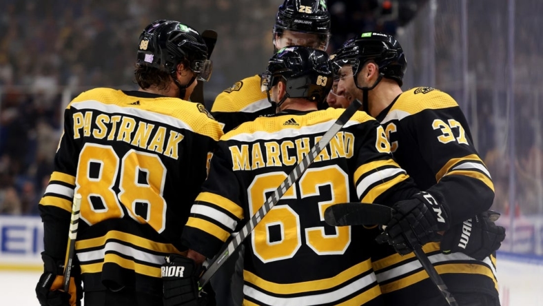 Nov 12, 2022; Buffalo, New York, USA;  Boston Bruins center Patrice Bergeron (37) celebrates his goal with teammates during the third period against the Buffalo Sabres at KeyBank Center. Mandatory Credit: Timothy T. Ludwig-USA TODAY Sports