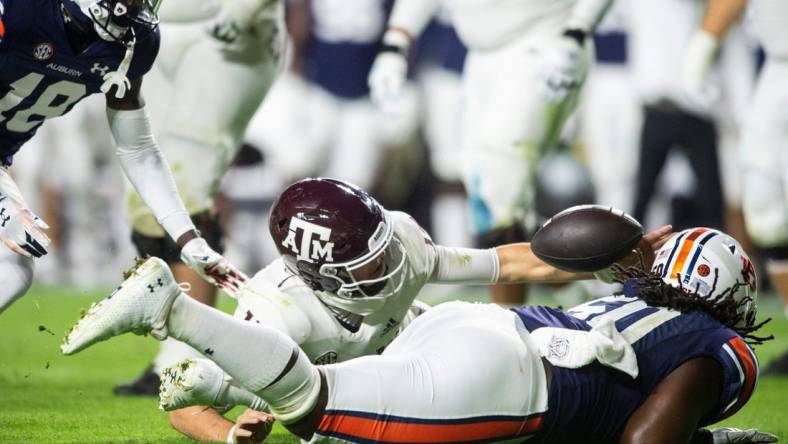 Texas A&M Aggies quarterback Conner Weigman (15) and Auburn Tigers defensive lineman Marcus Harris (50) dive for a fumble recovered by Weigman as Auburn Tigers take on Texas A&M Aggies at Jordan-Hare Stadium in Auburn, Ala., on Saturday, Nov. 12, 2022.