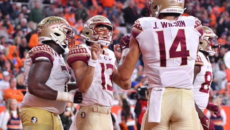 Nov 12, 2022; Syracuse, New York, USA; Florida State Seminoles quarterback Jordan Travis (13) celebrates catching a touchdown pass with wide receiver Johnny Wilson (14) in the third quarter against the Syracuse Orange at JMA Wireless Dome. Mandatory Credit: Mark Konezny-USA TODAY Sports
