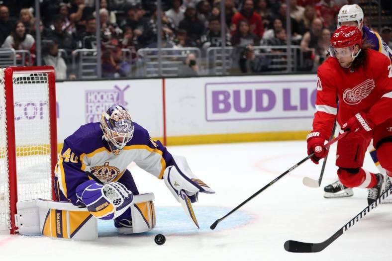 Nov 12, 2022; Los Angeles, California, USA;  Los Angeles Kings goaltender Cal Petersen (40) and Detroit Red Wings center Oskar Sundqvist (70) battles for the puck during the first period against the Detroit Red Wings at Crypto.com Arena. Mandatory Credit: Kiyoshi Mio-USA TODAY Sports