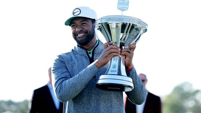 Nov 13, 2022; Houston, Texas, USA; Tony Finau raises the championship trophy after winning the Cadence Bank Houston Open golf tournament. Mandatory Credit: Erik Williams-USA TODAY Sports