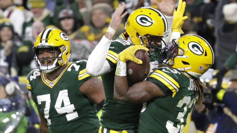 Nov 13, 2022; Green Bay, Wisconsin, USA; Green Bay Packers quarterback Aaron Rodgers (12) celebrates with Aaron Jones (33) after he scored a touchdown against the Dallas Cowboys at Lambeau Field. Mandatory Credit: Dan Powers/Appleton Post-Crescent-USA TODAY NETWORK