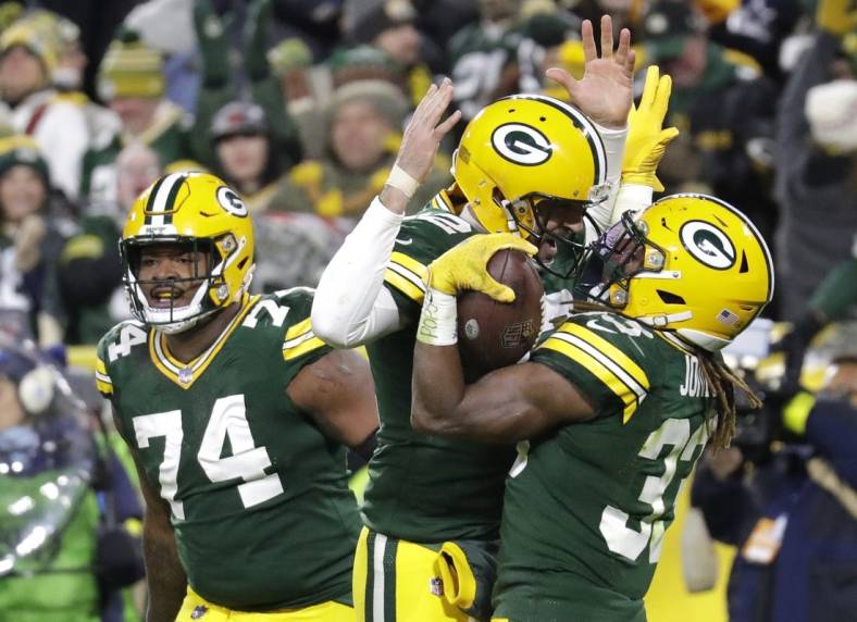 Nov 13, 2022; Green Bay, Wisconsin, USA; Green Bay Packers quarterback Aaron Rodgers (12) celebrates with Aaron Jones (33) after he scored a touchdown against the Dallas Cowboys at Lambeau Field. Mandatory Credit: Dan Powers/Appleton Post-Crescent-USA TODAY NETWORK