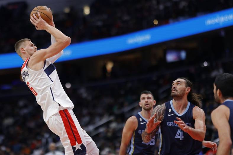 Nov 13, 2022; Washington, District of Columbia, USA; Washington Wizards center Kristaps Porzingis (6) shoots the ball over Memphis Grizzlies center Steven Adams (4) in the first quarter at Capital One Arena. Mandatory Credit: Geoff Burke-USA TODAY Sports
