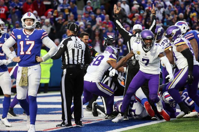 Vikings Patrick Peterson celebrates as Bills quarterback Josh Allen walks off the field.  Minnesota scored when Allen didn   t handle the snap at the goal line and the Vikings recovered the ball in the end zone.