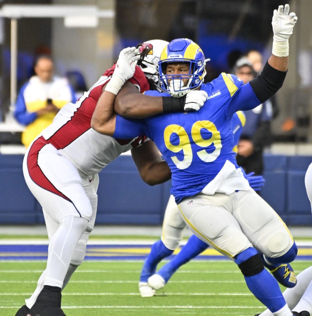 Nov 13, 2022; Inglewood, California, USA; Los Angeles Rams defensive tackle Aaron Donald (99) tries to slip past Arizona Cardinals guard Lecitus Smith (54) to get to quarterback Colt McCoy (not pictured) during the second quarter at SoFi Stadium. Mandatory Credit: Robert Hanashiro-USA TODAY Sports