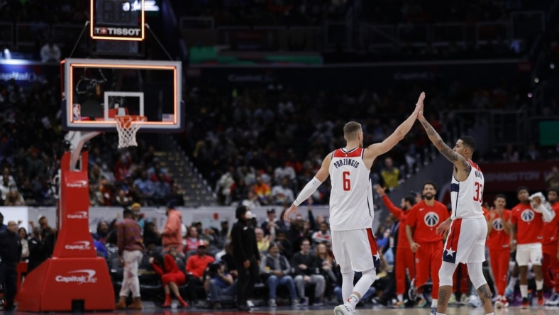 Nov 13, 2022; Washington, District of Columbia, USA; Washington Wizards center Kristaps Porzingis (6) celebrates with Wizards forward Kyle Kuzma (33) after making a three point field goal against the Memphis Grizzlies before the horn to end the second quarter at Capital One Arena. Mandatory Credit: Geoff Burke-USA TODAY Sports