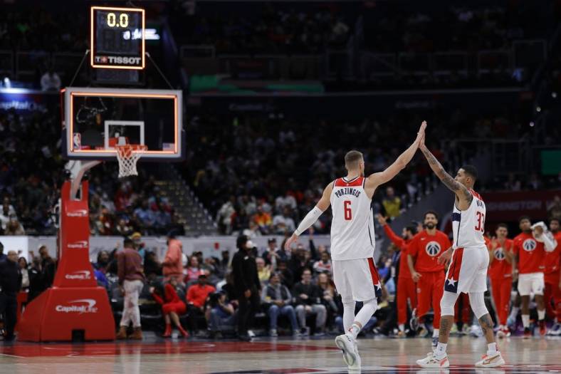 Nov 13, 2022; Washington, District of Columbia, USA; Washington Wizards center Kristaps Porzingis (6) celebrates with Wizards forward Kyle Kuzma (33) after making a three point field goal against the Memphis Grizzlies before the horn to end the second quarter at Capital One Arena. Mandatory Credit: Geoff Burke-USA TODAY Sports