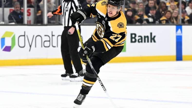 Nov 13, 2022; Boston, Massachusetts, USA; Boston Bruins defenseman Hampus Lindholm (27) shoots the puck during the first period of a game against the Vancouver Canucks  at the TD Garden. Mandatory Credit: Brian Fluharty-USA TODAY Sports
