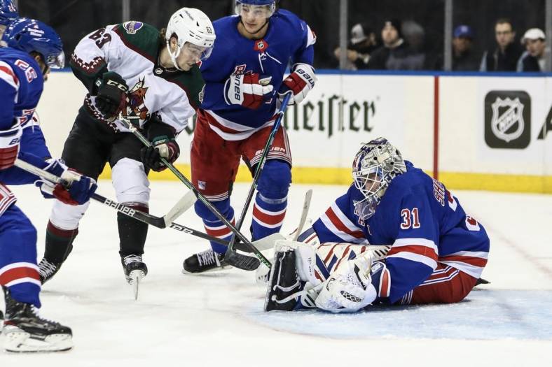 Nov 13, 2022; New York, New York, USA;  New York Rangers goaltender Igor Shesterkin (31) makes a save against Arizona Coyotes left wing Matias Maccelli (63) in the first period at Madison Square Garden. Mandatory Credit: Wendell Cruz-USA TODAY Sports