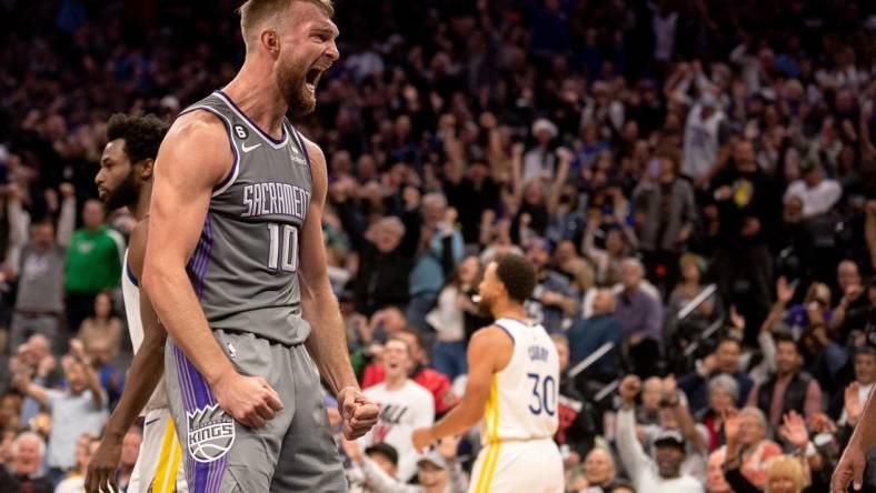 Nov 13, 2022; Sacramento, California, USA; Sacramento Kings forward Domantas Sabonis (10) celebrates after scoring during the fourth quarter against the Golden State Warriors at Golden 1 Center. Mandatory Credit: Ed Szczepanski-USA TODAY Sports