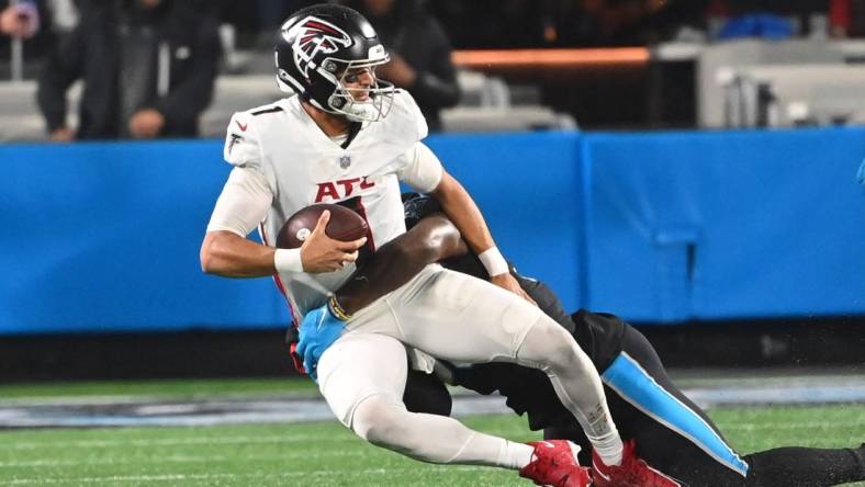 Nov 10, 2022; Charlotte, North Carolina, USA; Carolina Panthers defensive end Marquis Haynes Sr. (98) sacks Atlanta Falcons quarterback Marcus Mariota (1) in the fourth quarter at Bank of America Stadium. Mandatory Credit: Bob Donnan-USA TODAY Sports