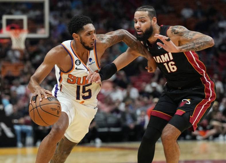 Nov 14, 2022; Miami, Florida, USA;Phoenix Suns guard Cameron Payne (15) drives past Miami Heat forward Caleb Martin (16) in the first half at FTX Arena. Mandatory Credit: Jim Rassol-USA TODAY Sports
