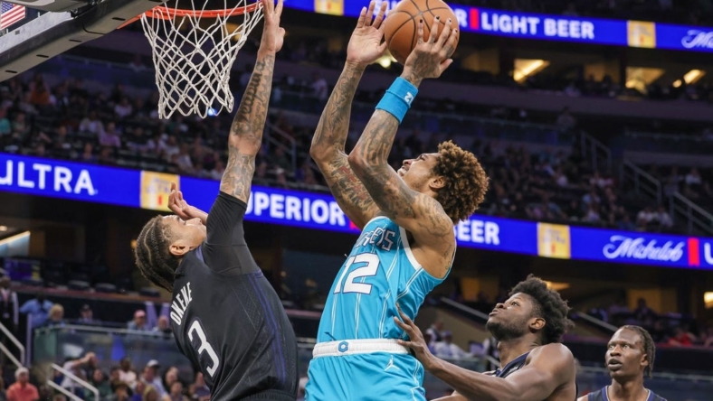 Nov 14, 2022; Orlando, Florida, USA; Charlotte Hornets guard Kelly Oubre Jr. (12) goes to the basket against Orlando Magic forward Chuma Okeke (3) during the second quarter at Amway Center. Mandatory Credit: Mike Watters-USA TODAY Sports