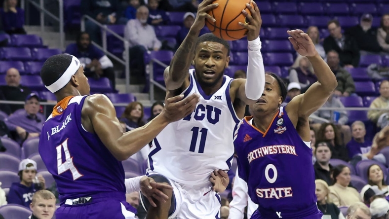 Nov 14, 2022; Fort Worth, Texas, USA;  TCU Horned Frogs guard Rondel Walker (11) drives to the basket as Northwestern State Demons guard JaMonta' Black (4) and Northwestern State Demons guard Demarcus Sharp (0) defend during the first half at Ed and Rae Schollmaier Arena. Mandatory Credit: Kevin Jairaj-USA TODAY Sports