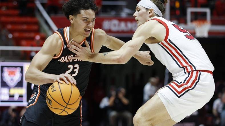 Nov 14, 2022; Salt Lake City, Utah, USA; Idaho State Bengals guard Maleek Arington (23) drives against Utah Utes guard Gabe Madsen (55) in the first half at Jon M. Huntsman Center. Mandatory Credit: Jeffrey Swinger-USA TODAY Sports