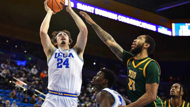 Nov 14, 2022; Los Angeles, California, USA; UCLA Bruins guard Jaime Jaquez Jr. (24) shoots against Norfolk State Spartans forward Dana Tate Jr. (21) during the first half at Pauley Pavilion. Mandatory Credit: Gary A. Vasquez-USA TODAY Sports