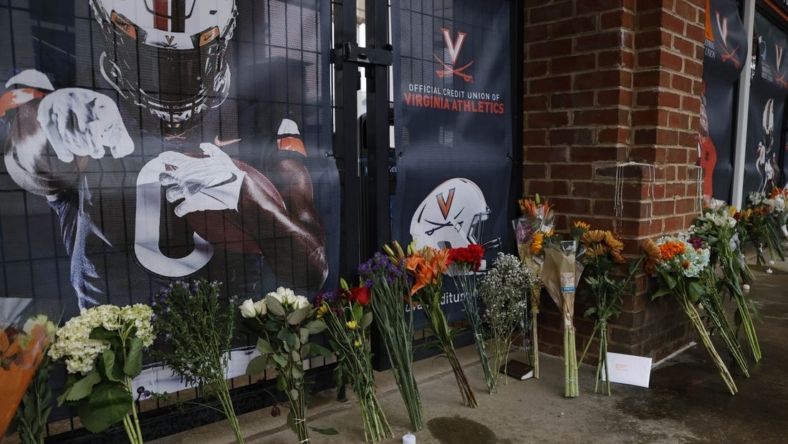 Nov 15, 2022; Charlottesville, Virginia, US; A view of flowers placed at a makeshift memorial outside Scott Stadium in memory of three Virginia Cavaliers football players who were killed in a shooting on the grounds of the University of Virginia in Charlottesville. Mandatory Credit: Geoff Burke-USA TODAY NETWORK