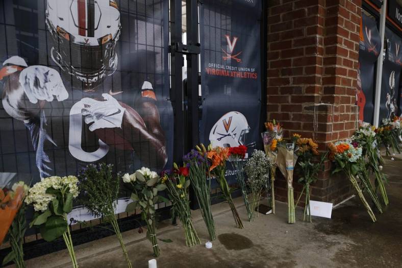 Nov 15, 2022; Charlottesville, Virginia, US; A view of flowers placed at a makeshift memorial outside Scott Stadium in memory of three Virginia Cavaliers football players who were killed in a shooting on the grounds of the University of Virginia in Charlottesville. Mandatory Credit: Geoff Burke-USA TODAY NETWORK