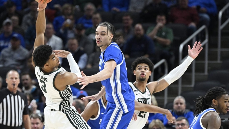 Nov 15, 2022; Indianapolis, Indiana, USA;  Michigan State Spartans guard Jaden Akins (3) passes the ball away from Kentucky Wildcats forward Lance Ware (55) during the first half at Gainbridge Fieldhouse. Mandatory Credit: Marc Lebryk-USA TODAY Sports