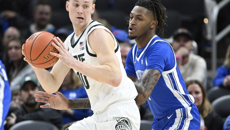Nov 15, 2022; Indianapolis, Indiana, USA;  Kentucky Wildcats forward Daimion Collins (4) guards Michigan State Spartans forward Joey Hauser (10) during the first half at Gainbridge Fieldhouse. Mandatory Credit: Marc Lebryk-USA TODAY Sports