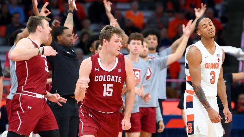 Nov 15, 2022; Syracuse, New York, USA; Colgate Raiders guard Tucker Richardson (15) gestures after his three-point basket as as Syracuse Orange guard Judah Mintz (3) reacts during the second half at the JMA Wireless Dome. Mandatory Credit: Rich Barnes-USA TODAY Sports