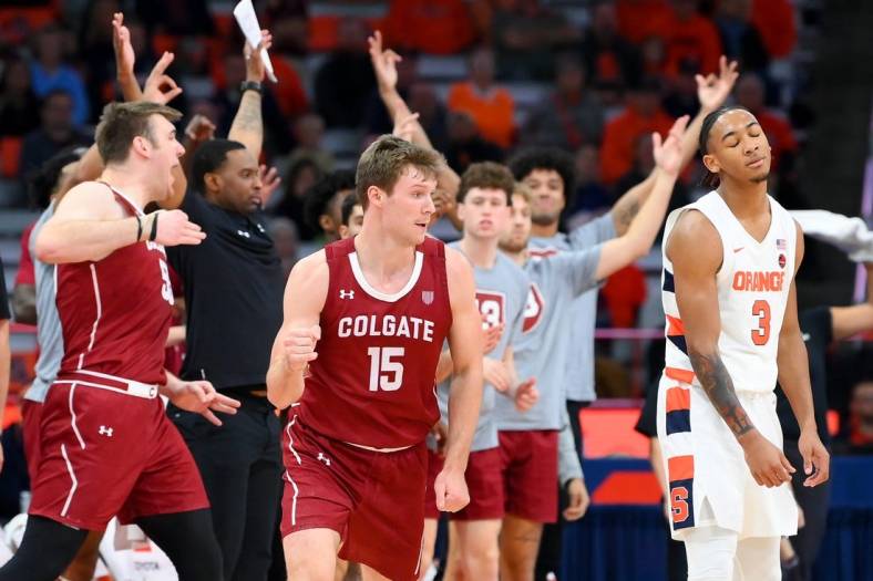 Nov 15, 2022; Syracuse, New York, USA; Colgate Raiders guard Tucker Richardson (15) gestures after his three-point basket as as Syracuse Orange guard Judah Mintz (3) reacts during the second half at the JMA Wireless Dome. Mandatory Credit: Rich Barnes-USA TODAY Sports