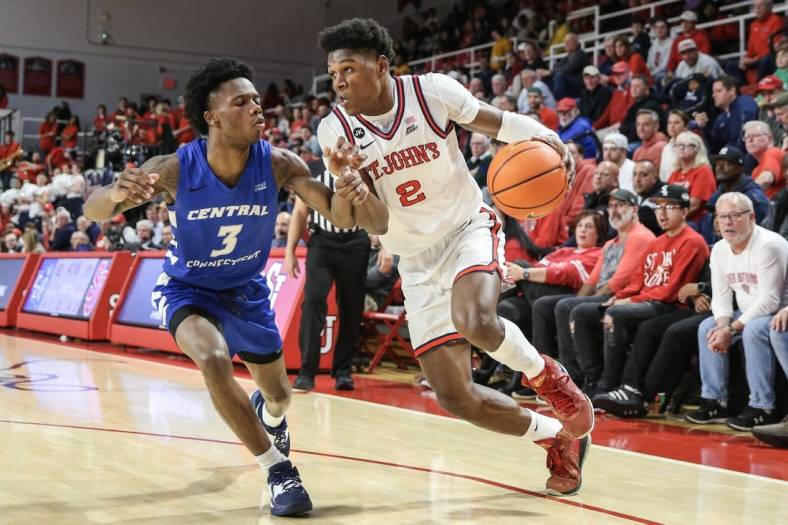 Nov 15, 2022; Queens, New York, USA;  St. John's Red Storm guard AJ Storr (2) drives past Central Connecticut State Blue Devils guard Nigel Scantlebury (3) in the second half at Carnesecca Arena. Mandatory Credit: Wendell Cruz-USA TODAY Sports