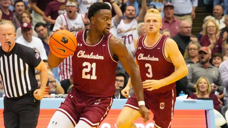 Nov 11, 2022; Chapel Hill, North Carolina, USA;  Charleston Cougars guard Jaylon Scott (21) dribbles the ball next to guard Dalton Bolon (3) during the first half at Dean E. Smith Center. Mandatory Credit: James Guillory-USA TODAY Sports