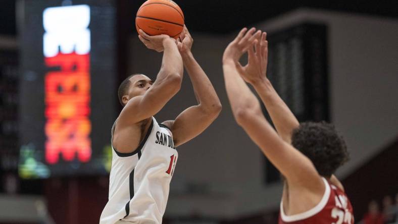 Nov 15, 2022; Stanford, California, USA;  San Diego State Aztecs forward Jaedon LeDee (13) shoots over Stanford Cardinal forward Brandon Angel (23) during the first half at Maples Pavilion. Mandatory Credit: Stan Szeto-USA TODAY Sports