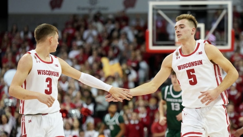 Nov 15, 2022; Madison, Wisconsin, USA; Wisconsin Badgers guard Connor Essegian (3) congratulates Wisconsin Badgers forward Tyler Wahl (5) on scoring against the Green Bay Phoenix during the first half at the Kohl Center. Mandatory Credit: Kayla Wolf-USA TODAY Sports