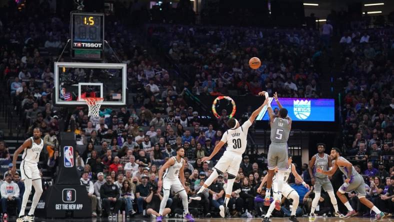 Nov 15, 2022; Sacramento, California, USA; Sacramento Kings guard De'Aaron Fox (5) makes a shot over Brooklyn Nets guard Seth Curry (30) at the end of the first quarter at the Golden 1 Center. Mandatory Credit: Cary Edmondson-USA TODAY Sports