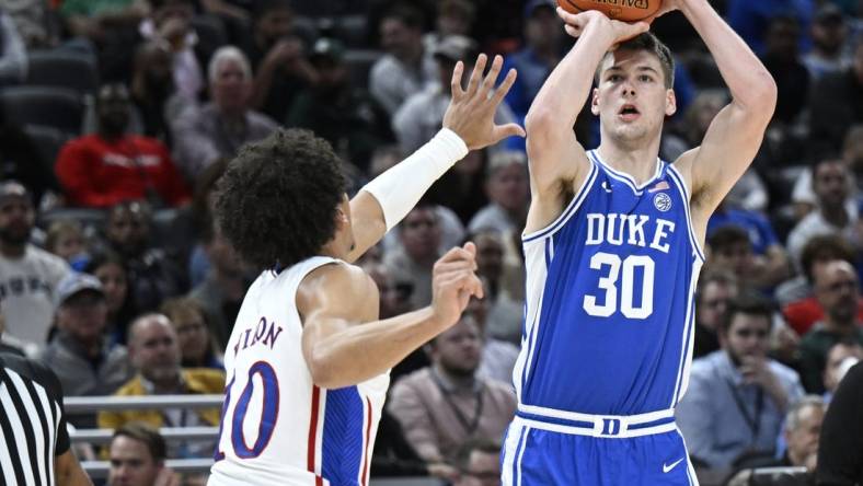 Nov 15, 2022; Indianapolis, Indiana, USA;  Duke Blue Devils center Kyle Filipowski (30) shoots the ball over Kansas Jayhawks forward Jalen Wilson (10) during the first half at Gainbridge Fieldhouse. Mandatory Credit: Marc Lebryk-USA TODAY Sports