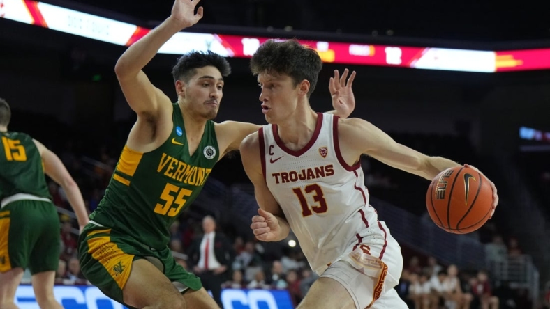 Nov 15, 2022; Los Angeles, California, USA; Southern California Trojans guard Drew Peterson (13) dribbles the ball against Vermont Catamounts guard Robin Duncan (55) in the first half at Galen Center. Mandatory Credit: Kirby Lee-USA TODAY Sports