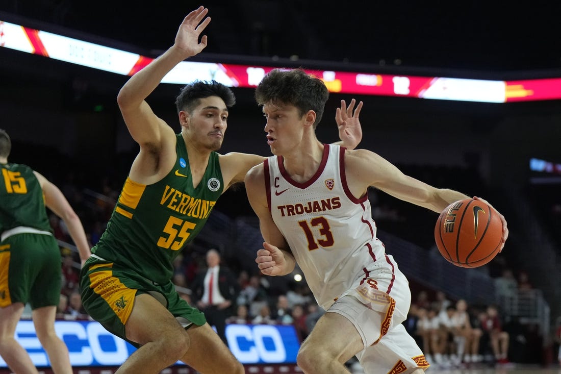 Nov 15, 2022; Los Angeles, California, USA; Southern California Trojans guard Drew Peterson (13) dribbles the ball against Vermont Catamounts guard Robin Duncan (55) in the first half at Galen Center. Mandatory Credit: Kirby Lee-USA TODAY Sports