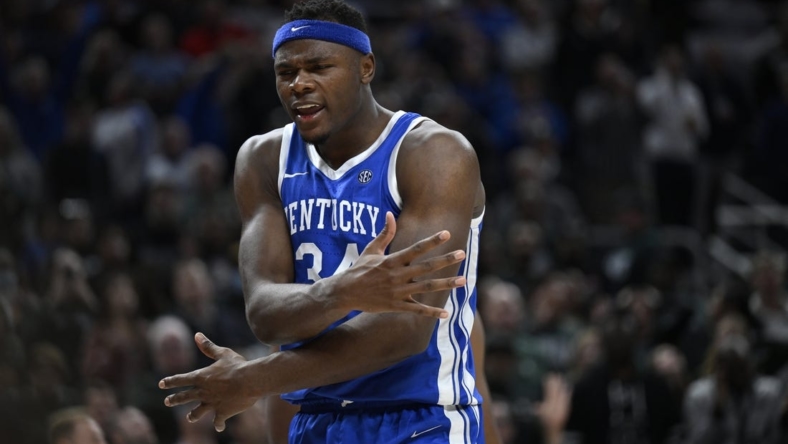 Nov 15, 2022; Indianapolis, Indiana, USA;  Kentucky Wildcats forward Oscar Tshiebwe (34) reacts to blocking a shot during the second half against the Michigan State Spartans at Gainbridge Fieldhouse. Spartans defeat the Wildcats 86 to 77 in double overtime. Mandatory Credit: Marc Lebryk-USA TODAY Sports
