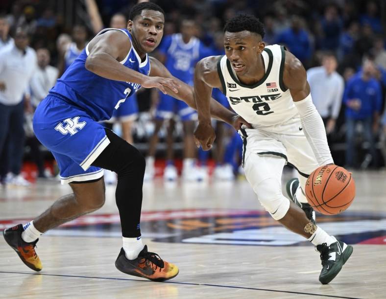 Nov 15, 2022; Indianapolis, Indiana, USA;  Michigan State Spartans guard Tyson Walker (2) drives the ball around Kentucky Wildcats guard Sahvir Wheeler (2) during the first overtime period at Gainbridge Fieldhouse. Spartans defeat the Wildcats 86 to 77 in double overtime. Mandatory Credit: Marc Lebryk-USA TODAY Sports