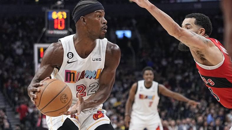 Nov 16, 2022; Toronto, Ontario, CAN; Miami Heat forward Jimmy Butler (22) looks for a play as Toronto Raptors guard Fred VanVleet (23) defends during the first quarter at Scotiabank Arena. Mandatory Credit: John E. Sokolowski-USA TODAY Sports