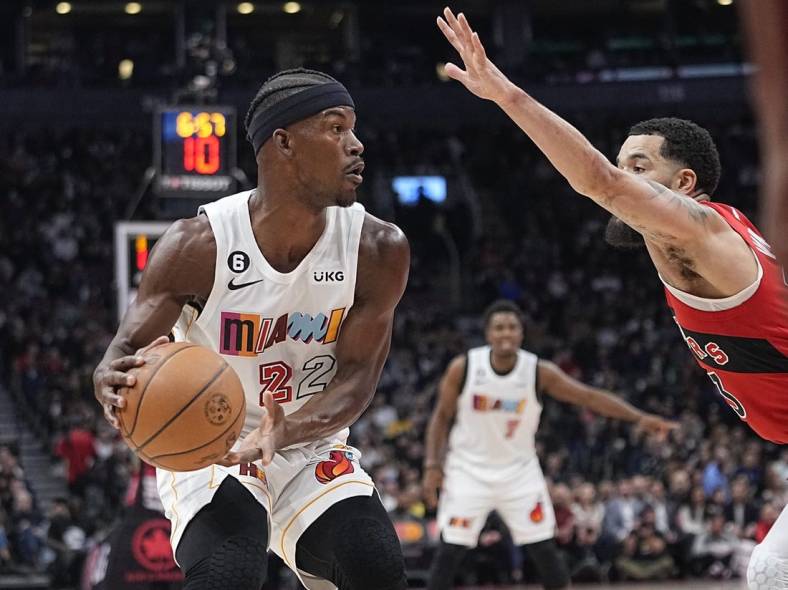 Nov 16, 2022; Toronto, Ontario, CAN; Miami Heat forward Jimmy Butler (22) looks for a play as Toronto Raptors guard Fred VanVleet (23) defends during the first quarter at Scotiabank Arena. Mandatory Credit: John E. Sokolowski-USA TODAY Sports