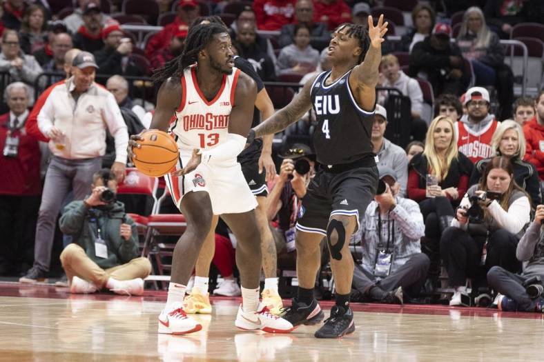 Nov 16, 2022; Columbus, Ohio, USA; Ohio State Buckeyes guard Isaac Likekele (13) looks for an open teammate as Eastern Illinois Panthers guard Yaakema Rose Jr. (4) defends in the first half at Value City Arena. Mandatory Credit: Greg Bartram-USA TODAY Sports