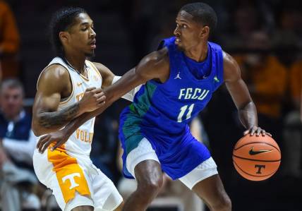 Nov 16, 2022; Knoxville, Tennessee, USA; Florida Gulf Coast Eagles guard Isaiah Thompson (11) controls the ball against Tennessee Volunteers guard Zakai Zeigler (5) during the first half at Thompson-Boling Arena. Mandatory Credit: Bryan Lynn-USA TODAY Sports