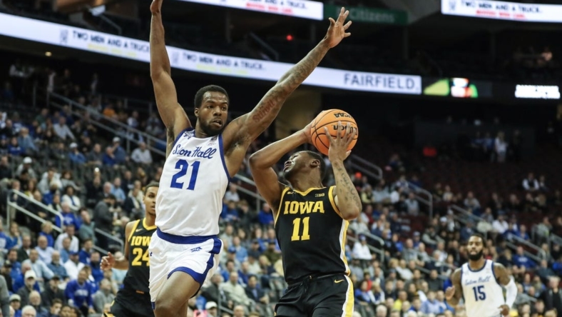 Nov 16, 2022; Newark, New Jersey, USA;  Iowa Hawkeyes guard Tony Perkins (11) attempts to drive past Seton Hall Pirates guard Femi Odukale (21) in the first half at Prudential Center. Mandatory Credit: Wendell Cruz-USA TODAY Sports