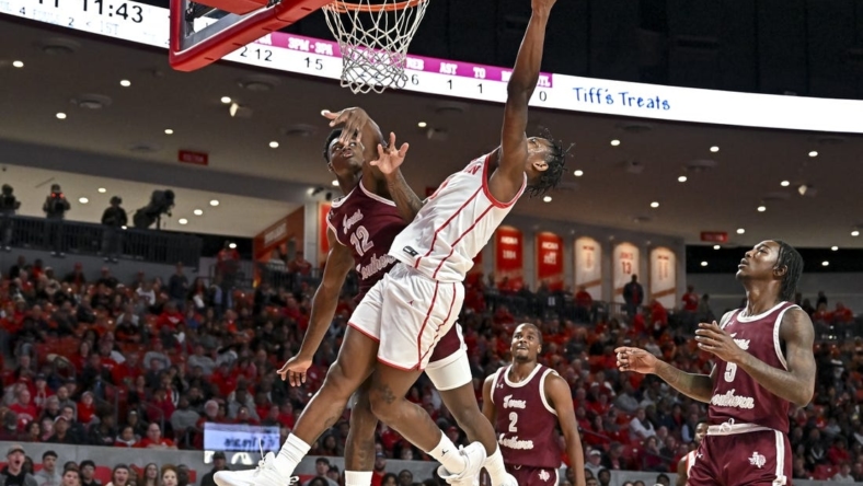 Nov 16, 2022; Houston, Texas, USA;  Houston Cougars guard Marcus Sasser (0) shoots over Texas Southern Tigers guard Zytarious Mortle (12) during the first half at Fertitta Center. Mandatory Credit: Maria Lysaker-USA TODAY Sports