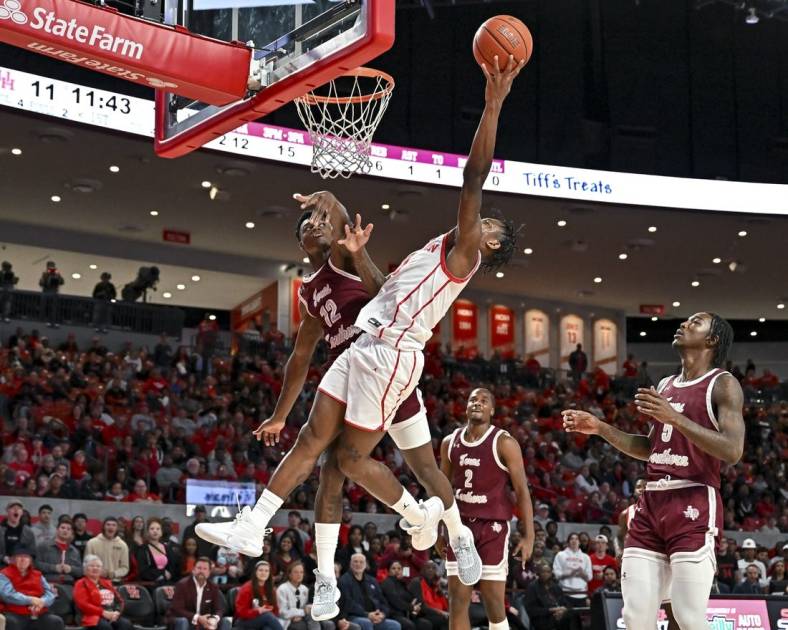 Nov 16, 2022; Houston, Texas, USA;  Houston Cougars guard Marcus Sasser (0) shoots over Texas Southern Tigers guard Zytarious Mortle (12) during the first half at Fertitta Center. Mandatory Credit: Maria Lysaker-USA TODAY Sports