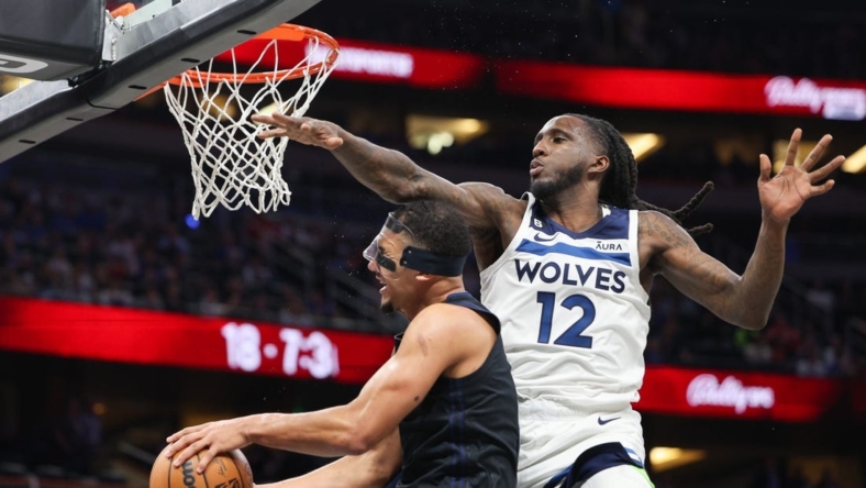 Nov 15, 2022; Tampa, Florida, USA;  Minnesota Timberwolves forward Taurean Prince (12) is called for a flagrant foul on Orlando Magic guard Jalen Suggs (4) in the third quarter at Amalie Arena. Mandatory Credit: Nathan Ray Seebeck-USA TODAY Sports