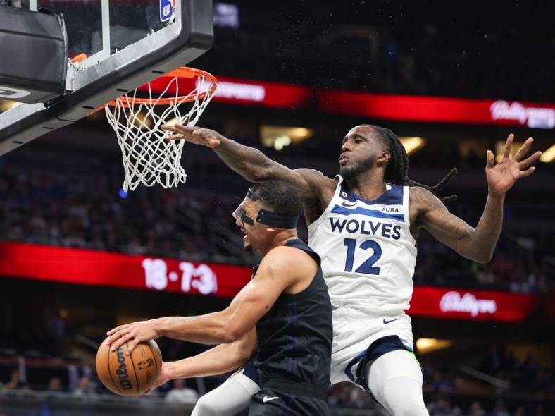Nov 15, 2022; Tampa, Florida, USA;  Minnesota Timberwolves forward Taurean Prince (12) is called for a flagrant foul on Orlando Magic guard Jalen Suggs (4) in the third quarter at Amalie Arena. Mandatory Credit: Nathan Ray Seebeck-USA TODAY Sports