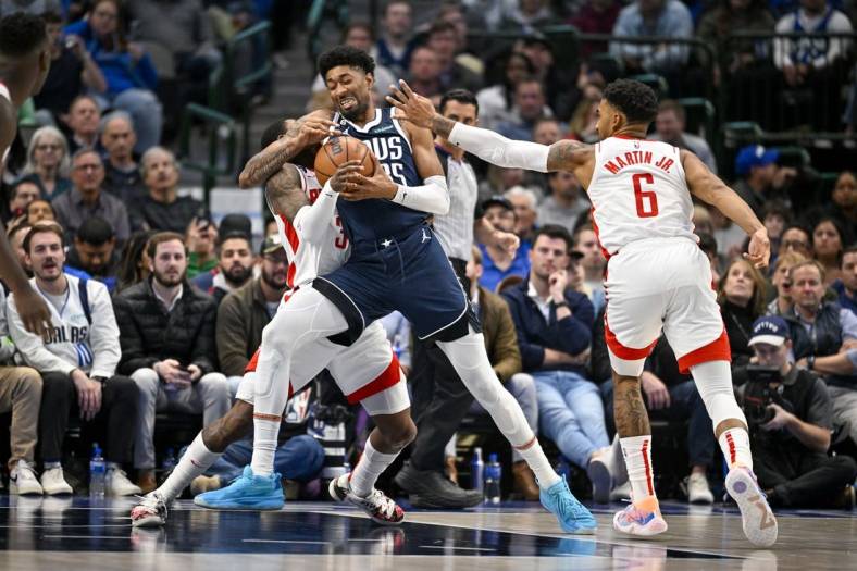 Nov 16, 2022; Dallas, Texas, USA; Houston Rockets guard Kevin Porter Jr. (3) and forward Kenyon Martin Jr. (6) defend against Dallas Mavericks center Christian Wood (35) during the second quarter at the American Airlines Center. Mandatory Credit: Jerome Miron-USA TODAY Sports