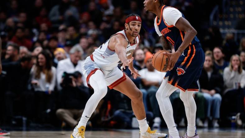 Nov 16, 2022; Denver, Colorado, USA; New York Knicks forward Cam Reddish (0) controls the ball as Denver Nuggets forward Zeke Nnaji (22) defends in the second quarter at Ball Arena. Mandatory Credit: Isaiah J. Downing-USA TODAY Sports