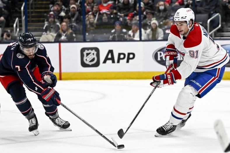 Nov 17, 2022; Columbus, Ohio, USA; Montreal Canadiens center Sean Monahan (91) and Columbus Blue Jackets center Sean Kuraly (7) battle for the puck in the first period at Nationwide Arena. Mandatory Credit: Gaelen Morse-USA TODAY Sports